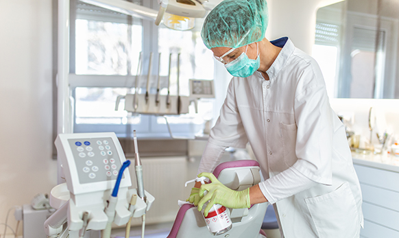 Female doctor cleaning dental office